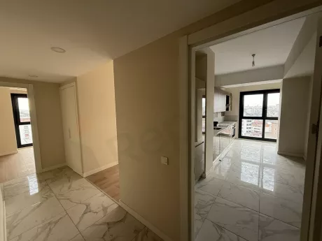 Spacious and bright hallway view of a modern apartment.