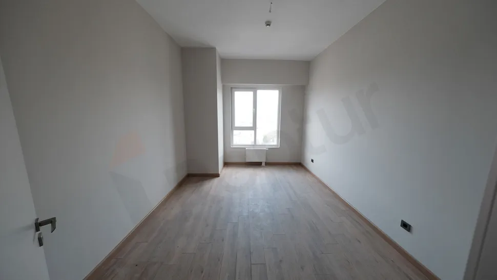 Spacious bedroom area of a modern and bright apartment.