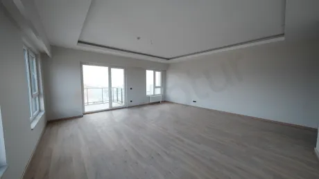 Spacious and bright living room interior with modern architecture and ample natural light.