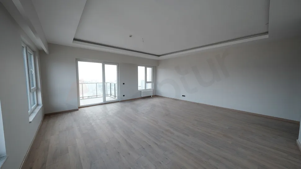 Spacious and bright living room interior with modern architecture and ample natural light.