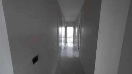 Spacious corridor with minimalist design in a modern and bright building interior.