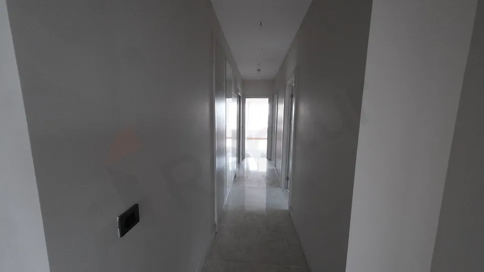 Spacious corridor with minimalist design in a modern and bright building interior.