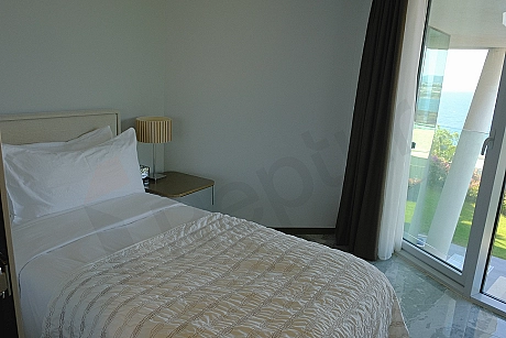 A spacious and bright bedroom view decorated with modern furniture.