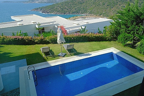 Spacious and clear outdoor swimming pool area with a modern design.