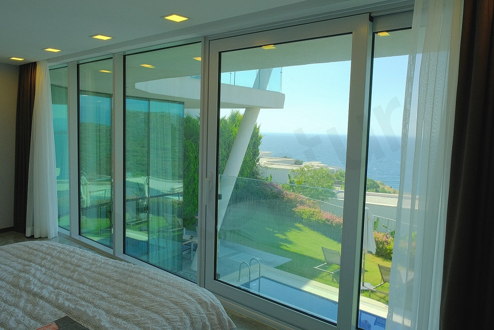 Panoramic sea view showing the deep blue water, coastline, and horizon from a beachfront villa in Bodrum.