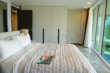Spacious and bright luxury villa bedroom image decorated with modern furniture.