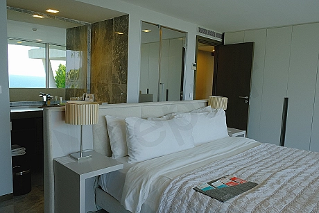 A spacious and brightly lit bedroom view decorated with modern furniture.