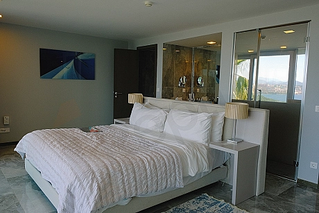 Spacious and bright bedroom interior decorated with modern furniture.