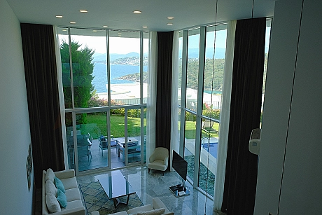 A spacious and bright living room design furnished with modern furniture.