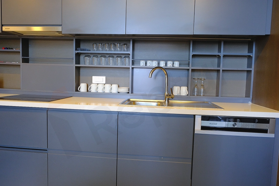 Modern and stylish kitchen interior with sleek cabinets and spacious countertops in a furnished villa.