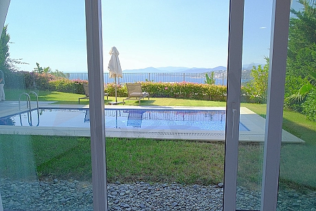 Outdoor swimming pool of a luxury villa with clear blue water and modern design.