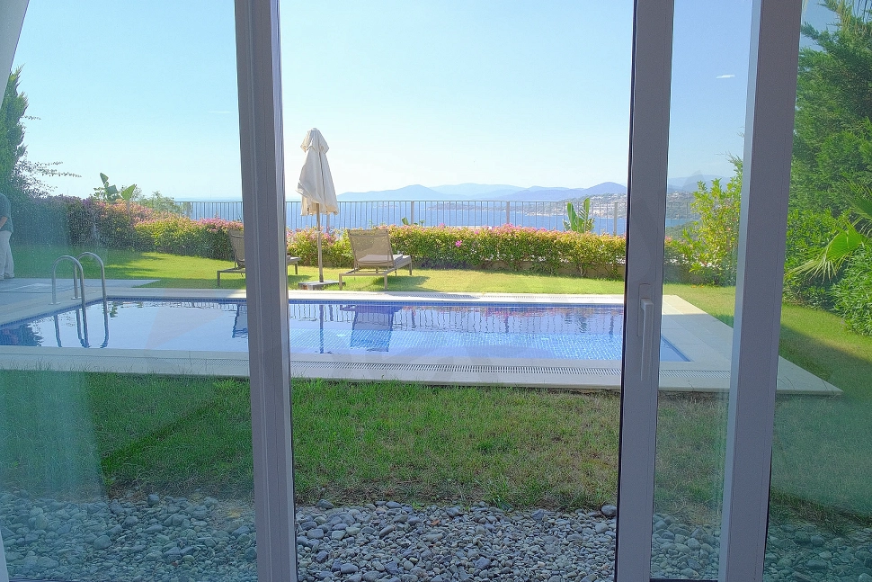 Outdoor swimming pool of a luxury villa with clear blue water and modern design.