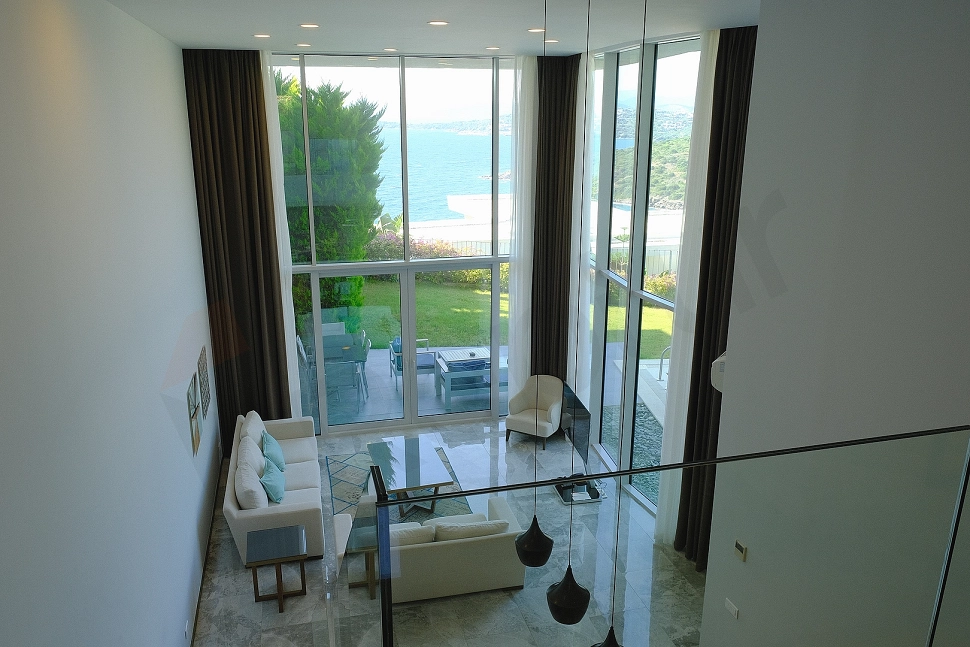 Spacious living room of a luxury villa decorated with modern and premium furniture.