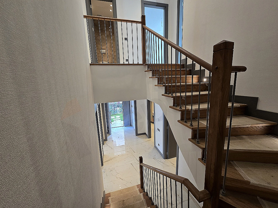 Interior view of a spacious and bright villa corridor.