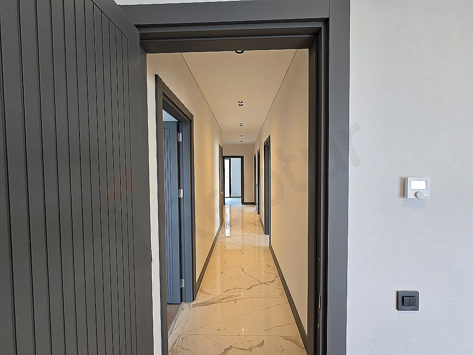 Interior view of a spacious and bright villa corridor.