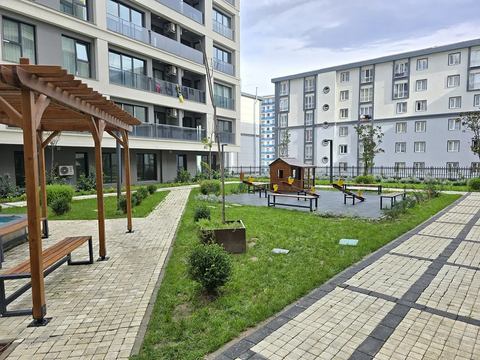 Outdoor children's playground with colorful slides and safety flooring.