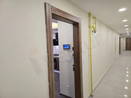 Entrance door and hallway of a modern apartment unit.
