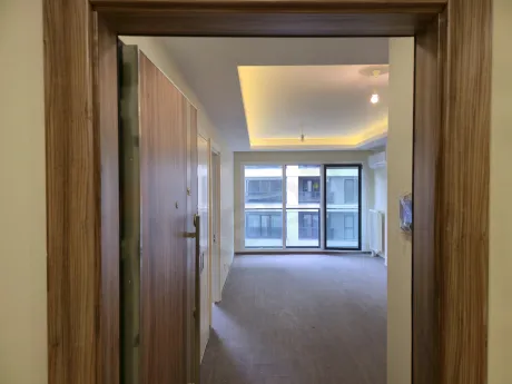 View of the entrance door and hallway section of a modern apartment.