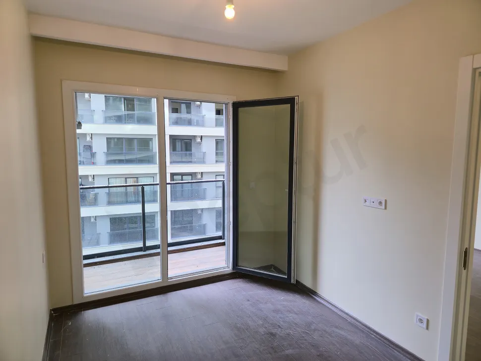 Spacious and bright bedroom area of a modern apartment.