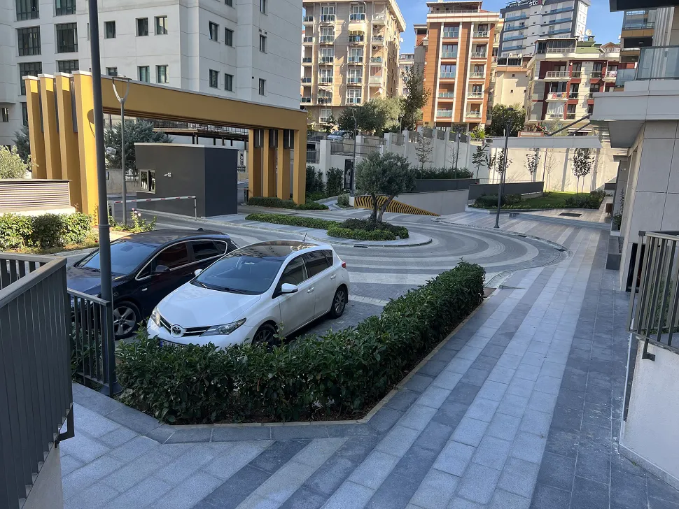 Spacious and well-lit indoor parking area of a modern residential project.