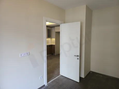 Modern and spacious bedroom interior of a 1+1 apartment for sale in Esenyurt, Istanbul.