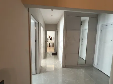 View of a modern internal staircase with wooden steps inside the apartment.