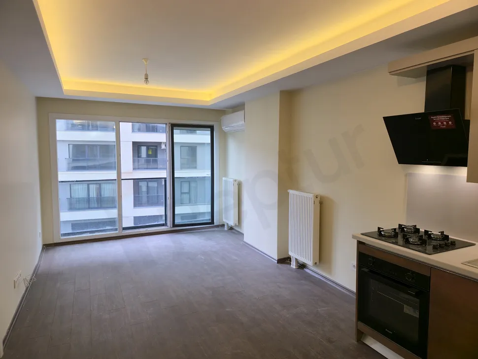 Spacious and sunlit living room area of a modern 1+1 apartment located in Esenyurt.