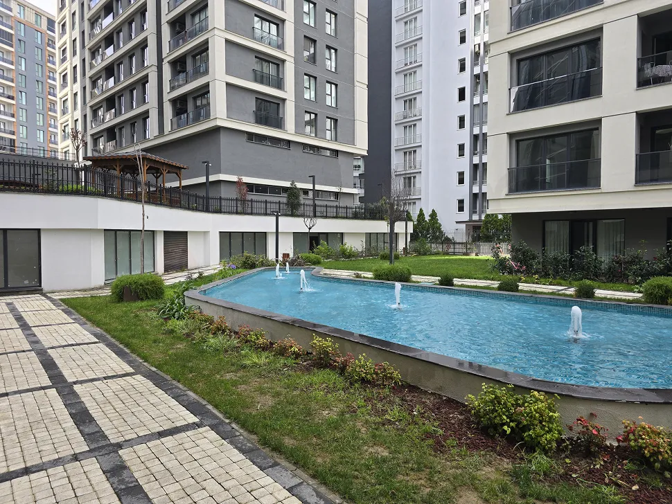 Landscaped green garden and outdoor area of a modern residential complex.