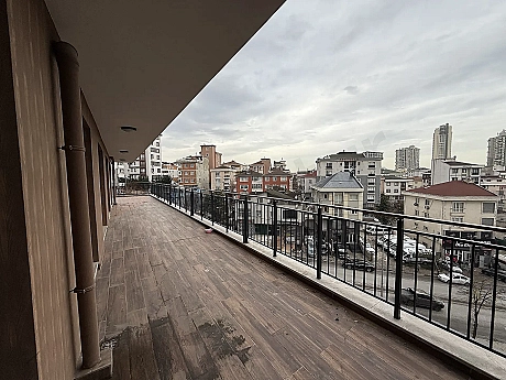 Spacious and modern apartment terrace with a city view.