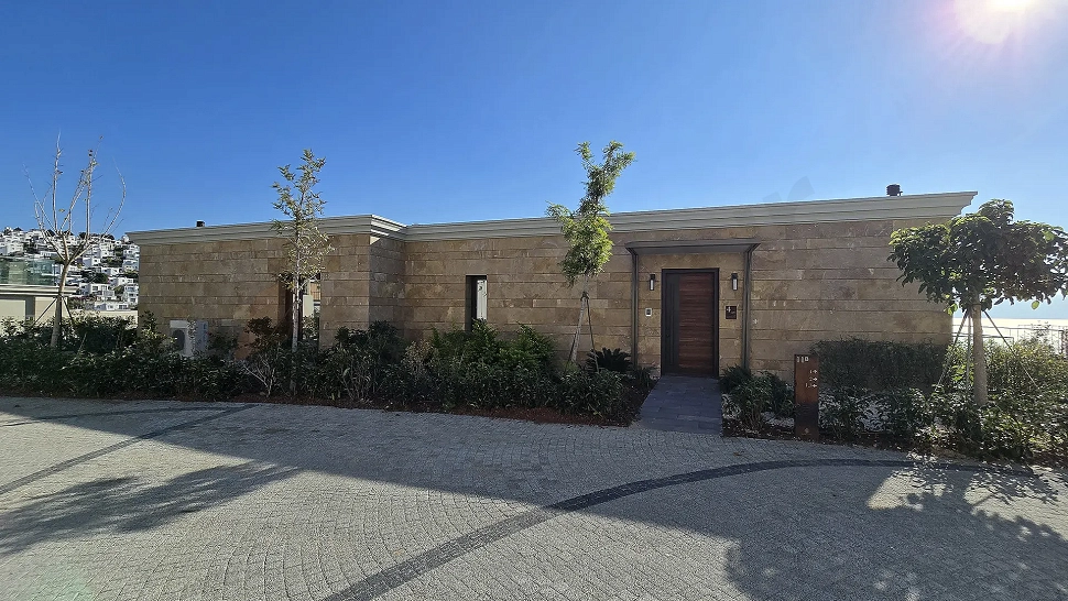 Exterior view of a luxury residence with modern architecture located on the seafront in Bodrum.