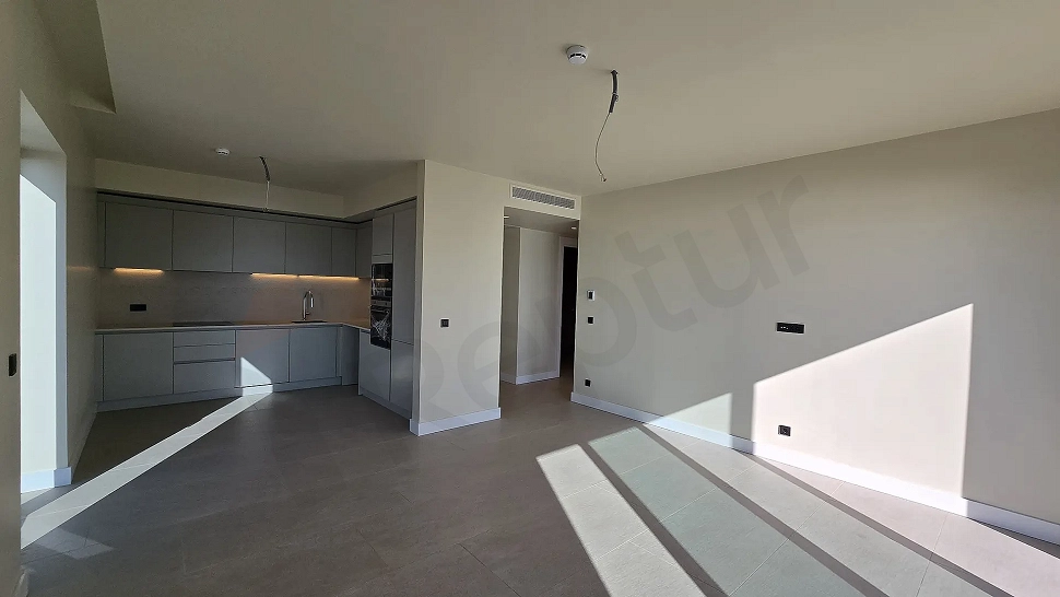 Spacious and bright living room area of a 2+1 residence apartment for sale in Bodrum.