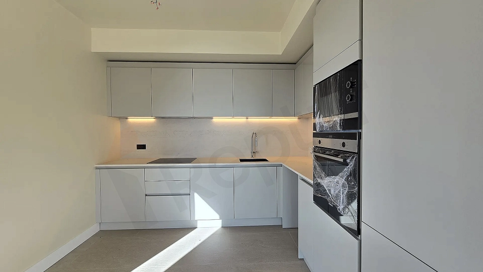 Modernly designed, spacious and bright kitchen area.