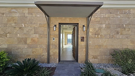 Entrance door and hallway of a modern apartment unit.
