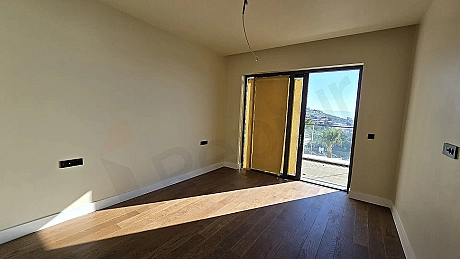 Modern and spacious bedroom area of a luxury apartment in Bodrum.