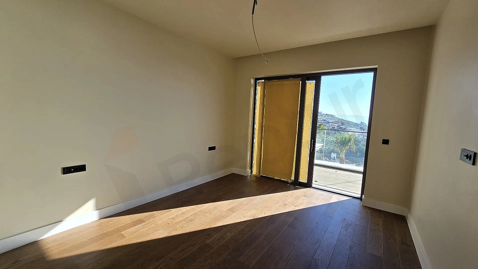 Modern and spacious bedroom area of a luxury apartment in Bodrum.