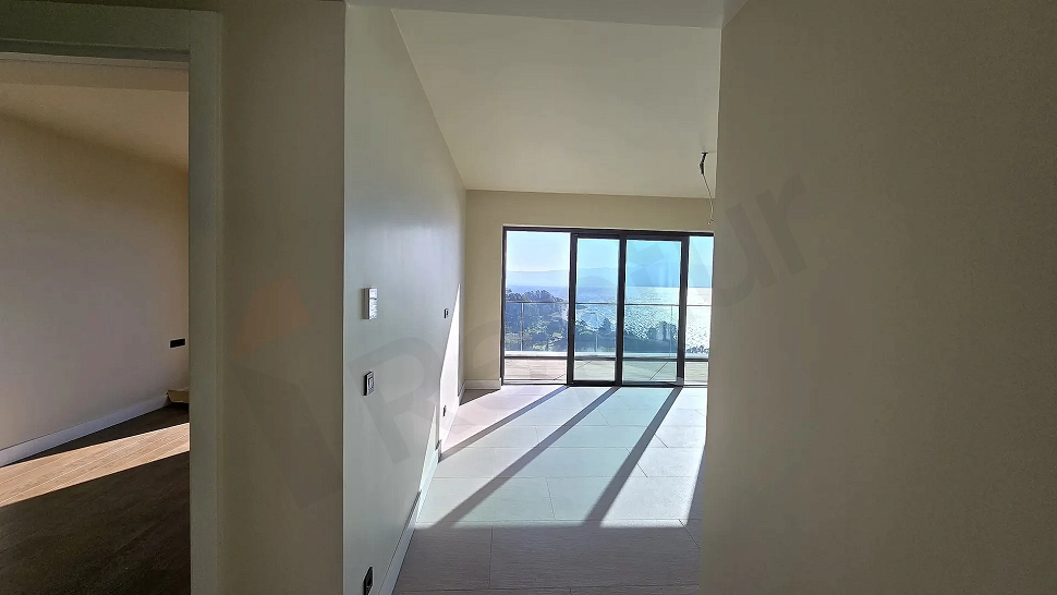 Spacious and bright modern living room interior with large windows.