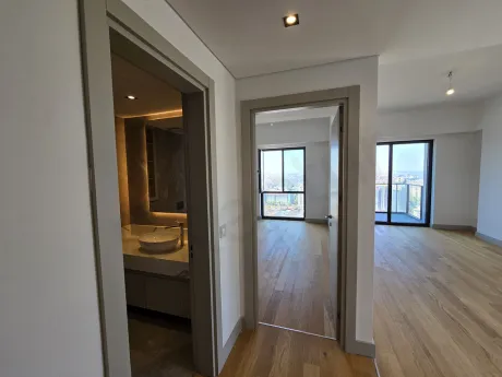 Elegant wooden internal staircase inside a modern luxury apartment.