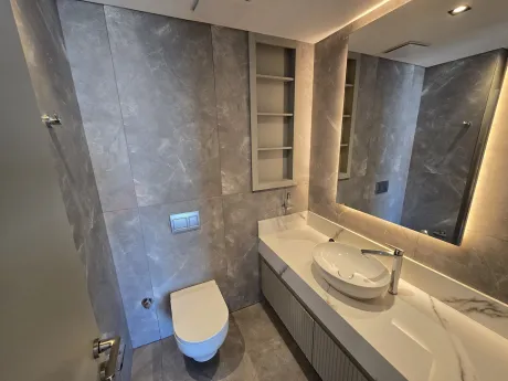 Modern and stylishly designed spacious bathroom with ceramic tiling.