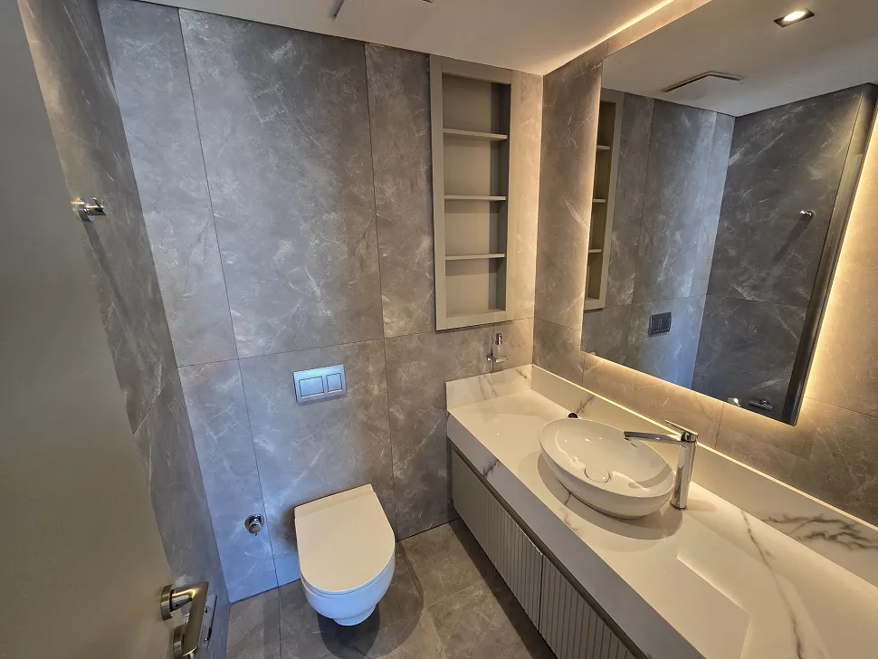 Modern and stylishly designed spacious bathroom with ceramic tiling.