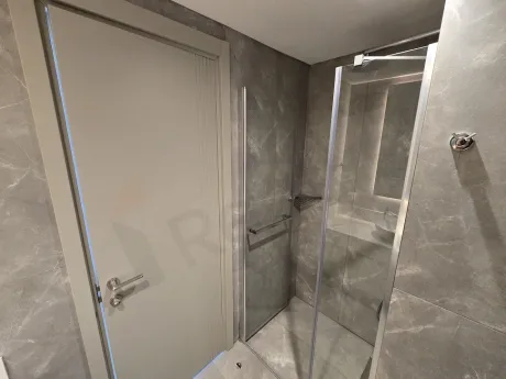 Image of a modernly designed, spacious, and bright bathroom area.