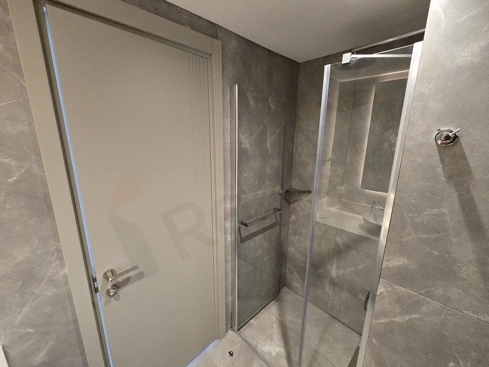 Image of a modernly designed, spacious, and bright bathroom area.