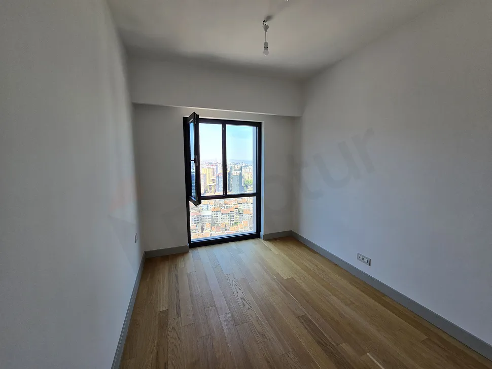 Spacious and bright bedroom area of a luxury 1+1 apartment in a modern residence project in Sisli.