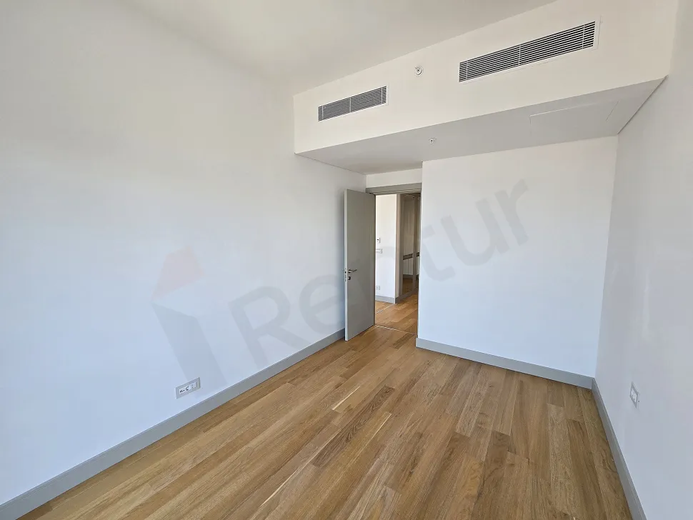 Spacious and bright empty bedroom view of a modern residence apartment in Sisli, Istanbul.