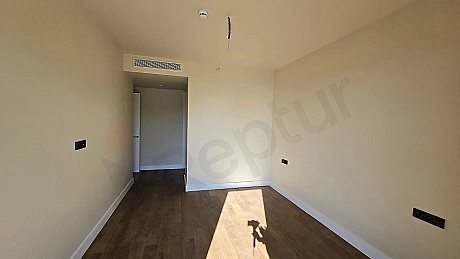 Interior view of a spacious and bright bedroom with modern design.