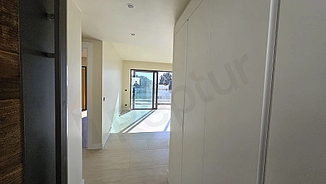 Hallway view of a modern and bright residence apartment.