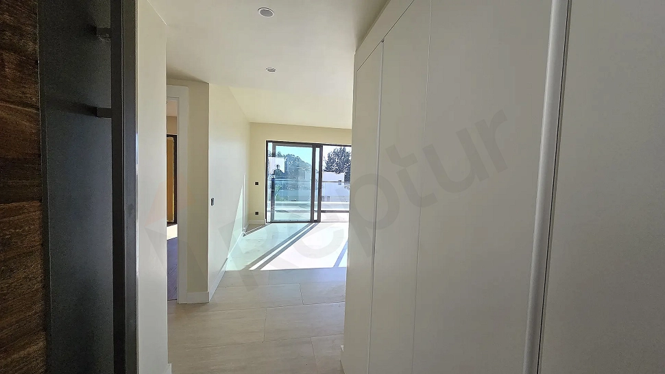 Hallway view of a modern and bright residence apartment.