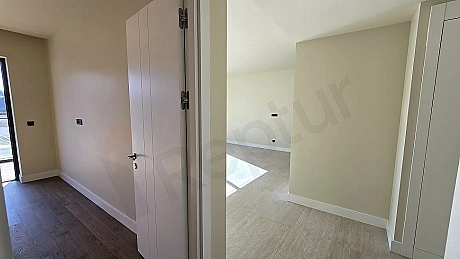 Spacious and bright bedroom view of a modern apartment for sale in Bodrum.