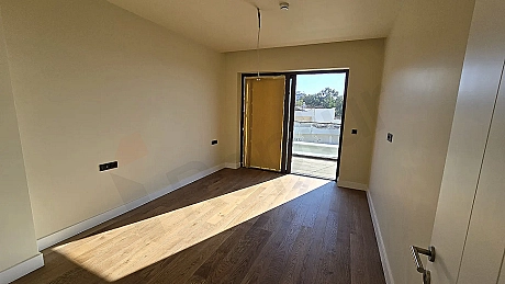 Interior view of a spacious and bright bedroom with modern design.