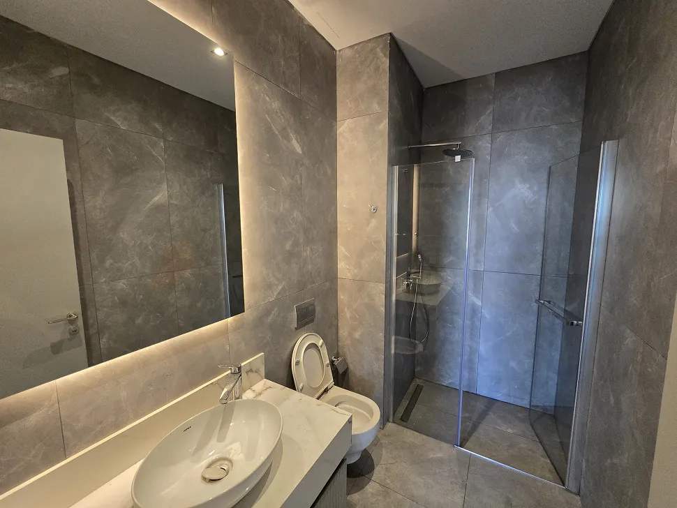 Spacious and bright residence bathroom designed with modern fixtures and stylish ceramics.