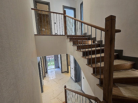 Interior view of a spacious and bright villa corridor.
